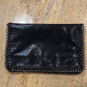 Black clutch with silver chain along the hem
